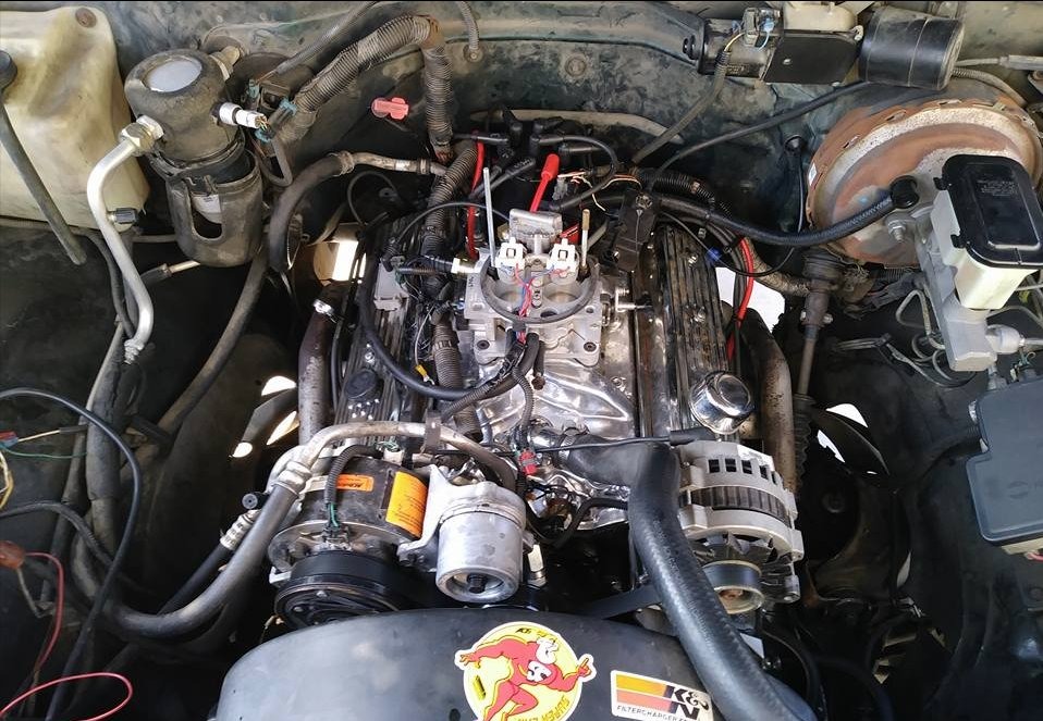 Engine bay close-up of a GM small-block with throttle-body injection and K&N air filter